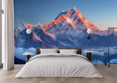 The mountain range is covered in snow and the sun is setting behind it Wall mural