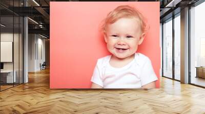 portrait caucasian curly blond smiling baby girl with two teethon pink background wearing in white t-shirt. copy space. Wall mural