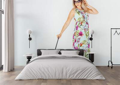 girl in a summer dress with a bright colored suitcase on a white background, the concept of summer vacation and tourism Wall mural