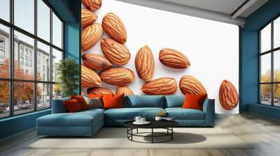 A close-up view of raw almonds scattered on a light background showcasing their natural texture and color Wall mural