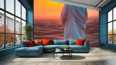 An Arab man looks at the desert. Selective focus. Wall mural