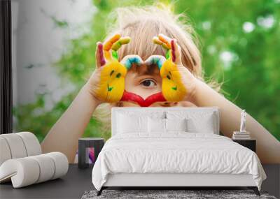 children hands in colors. Summer photo. Selective focus. Wall mural