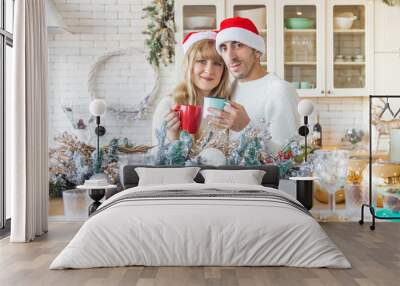 Man and woman in the kitchen Christmas photo. Selective focus. Wall mural