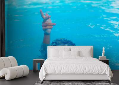 The child is drowning in the sea. Selective focus. Wall mural