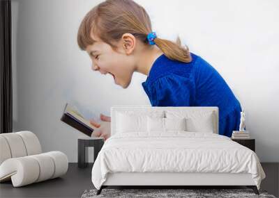 The child is reading a book. Selective focus.   Wall mural