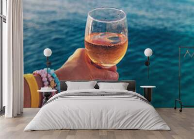 Wine in a glass on the seashore. Selective focus. Wall mural