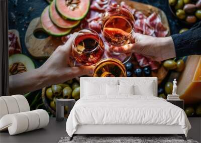 Wine in the hands of friends against the background of food. Selective focus. Wall mural