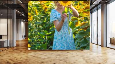 Woman in a field of sunflowers. Ukraine. Selective focus. Wall mural