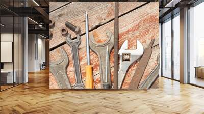 a set of hand tools old, rusty made with metal. On wooden boards are wrenches, screwdriver, file, bolts, nuts, adjustable spanner Wall mural