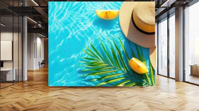 two straw hats next to palm leaves, lemon slices on a blue background with waves, empty space for text, summer banner Wall mural