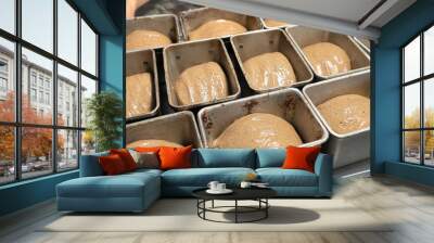 Bread dough in a black metal baking dish on a kitchen countertop. Rye-free rye bread Wall mural