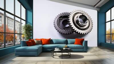 New parts on a gray background. Gears of gear shifting torque transmission. Conceptually mechanical background. Shiny gear box gear teeth Wall mural