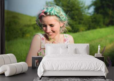 Portrait of a young happy smiling girl in a cotton dress with a bouquet of wildflowers Wall mural