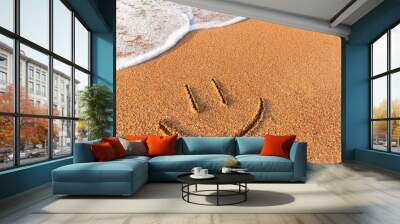 Smiley drawn on the sandy beach, travel and vacation concept. sea wave, top view of the sandy beach. Face in the sand at the beach Wall mural