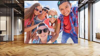 funny portrait of group of teenagers spending time together Wall mural