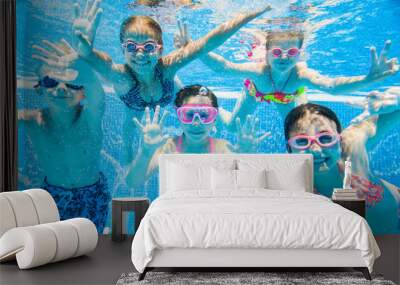 little kids swimming  in pool  underwater. Wall mural