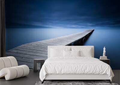 Dark blue atmosphere around a pier to the lake of Sanguinet Wall mural