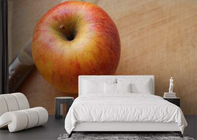 Red apple and knife resting on a cutting board Wall mural