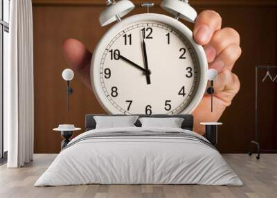 Alarm clock in a man's hand. Close-up. Wall mural