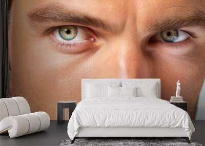 Close-up portrait of a handsome young man with green eyes. Wall mural