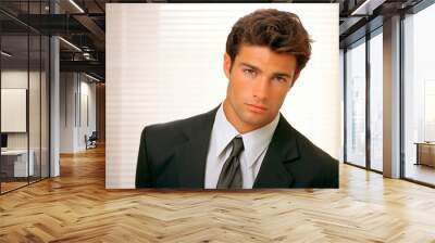 Portrait of a handsome young man in suit looking at the camera Wall mural