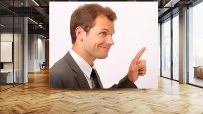 Portrait of a young businessman pointing at copy space on white background Wall mural