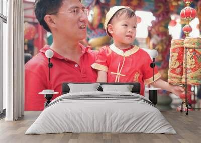 asian family celebrating chinese new year, cute little 2 years old toddler boy child in traditional  Wall mural