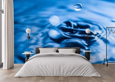 water drop splash in a glass blue colored Wall mural