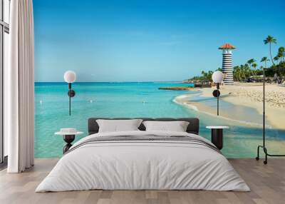 Paradise Caribbean landscape. Clear sea, white sand, tropical palm trees and lighthouse on sandy shore Wall mural