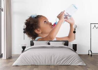 the little girl drinks water from a bottle. Wall mural