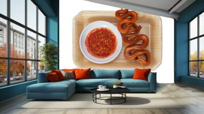 Grilled snake on skewer with chili sauce on white plate on mat Wall mural