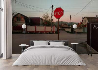 Red stop sign by old building facade. Wall mural