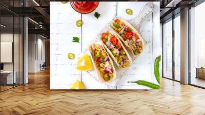 Taco - wheat tortilla with meat, vegetables, corn, greens. Delicious mexican snack on a white wooden background. Street food. Wall mural