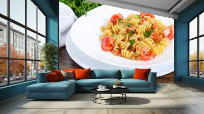 Warm salad with seafood in a white bowl on a wooden background. Pasta Radiatori with crayfish, shrimp, tomatoes, herbs and creamy garlic sauce. Wall mural