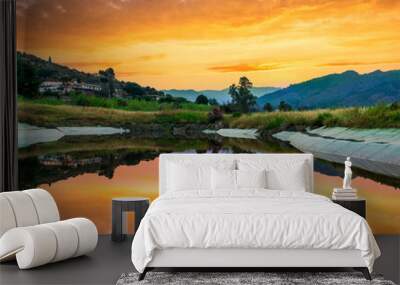 Amazing view at scenic landscape on a beautiful river and colorful sunset with reflection on water surface and glow on a background, spring season landscape Wall mural