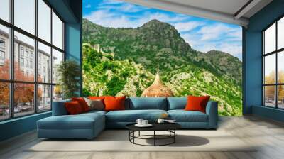 Antique architecture chapel with old nice dome and medieval church with cupola on foreground and high green natural mountain on background Wall mural