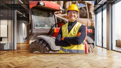 Cheerful matured man in safety helmet and work vest looking at camera and smiling while keeping arms crossed Wall mural