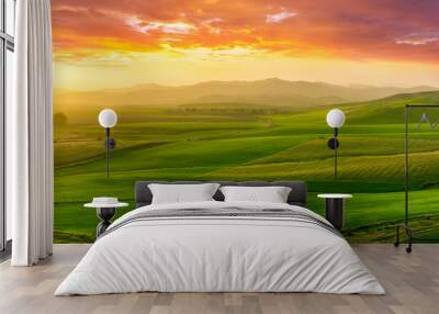 beautiful green valley with green fields with green spring grass with nive hills and mountains and scrnic colorful cloudy sunset on background of landscape Wall mural