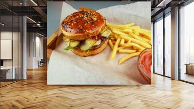 Burger with beef, chicken and french fries. Wooden plate. Gray background. Submission of the restaurant. Wall mural