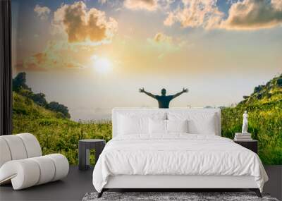 happy man watching amazing highland evening sunset, person delight with nature landscape Wall mural