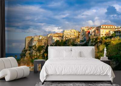 scenic travel landscape of beautiful historic town Tropea in Italy with old antique buildings, vintage houses on a high rock cliff above sea and amazing blue sky on background Wall mural