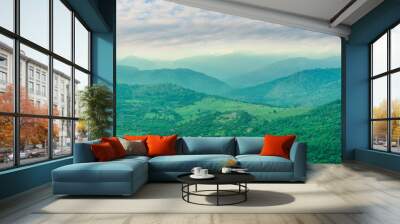 sunset valley landscape with green trees and gardens among beautiful mountains with colorful cloudy sky on background Wall mural