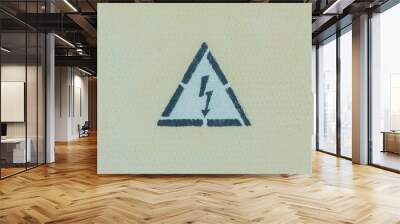 High voltage warning sign on a light yellow metal wall Wall mural