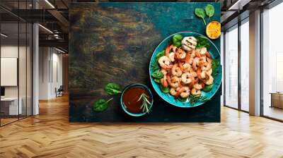 A plate of grilled shrimp with herbs, garlic and lemon. On a dark stone background. Top view. Wall mural