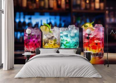 A set of colored alcoholic cocktails in glasses on the bar counter. Close-up, side view. On a dark background. Wall mural