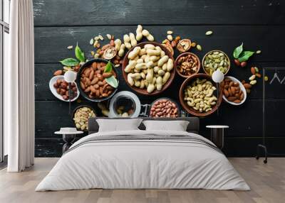 Assorted nuts on the old black background. Top view. Free space for your text. Wall mural