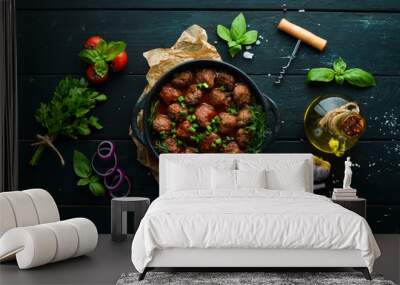 Baked meat balls with tomato sauce in a frying pan. Top view. Free copy space. Wall mural