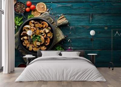 Baked mushrooms in a frying pan. Champignons. Top view. Free space for your text. Wall mural