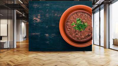 Bean. Haricot Soup. Georgian traditional cuisine. On the old wooden background. Free space for text. Top view. Wall mural