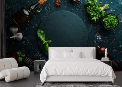 Black culinary background with spices and vegetables on the table. Top view. Free space for your text. Wall mural